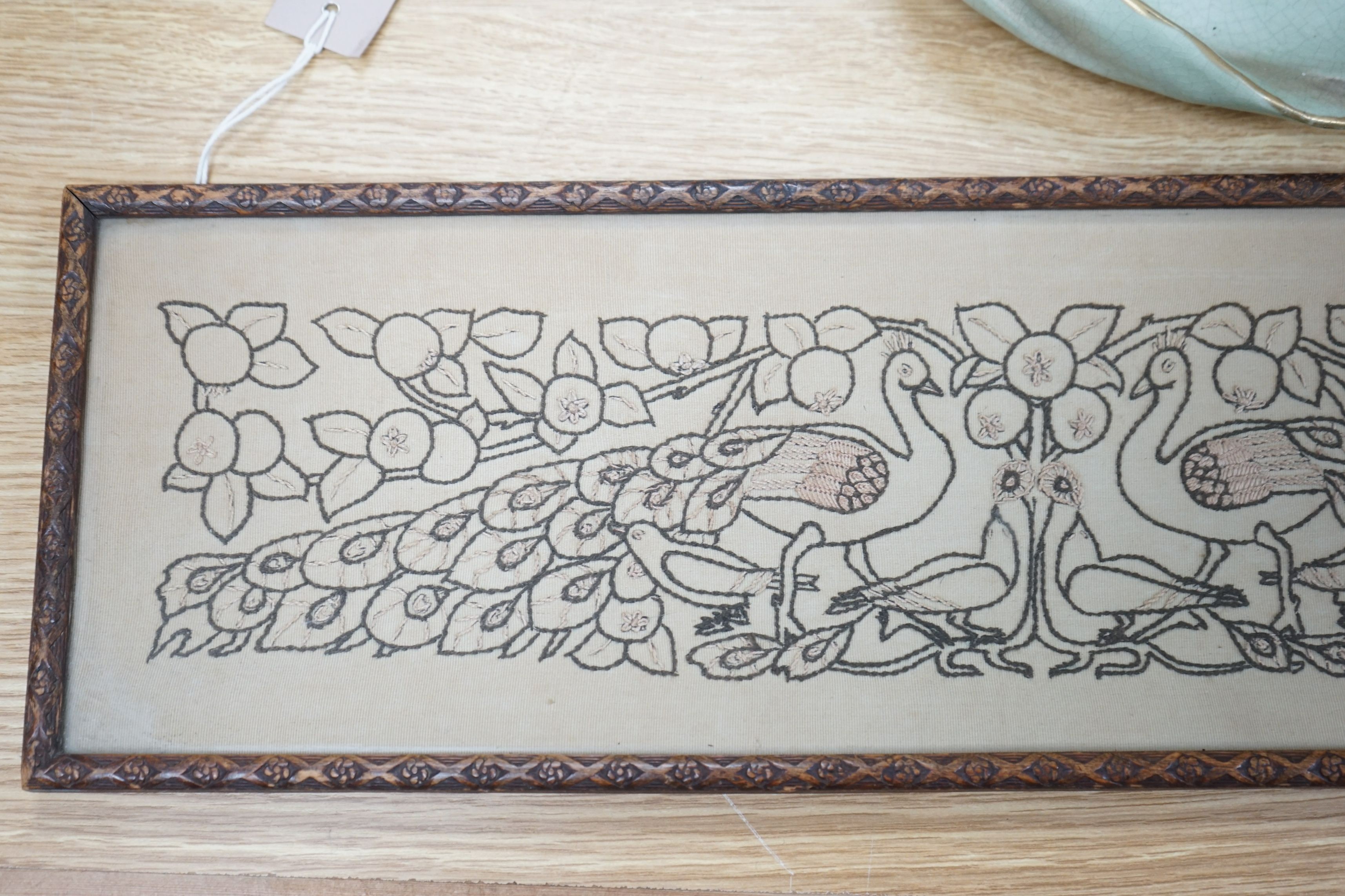 An Arts & Crafts peacock framed embroidered panel, 15.5cms high x 54.5cms wide